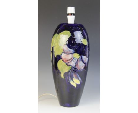 A Moorcroft 'Anemone' pattern lamp base, of tapering ovoid form against a cobalt ground, impressed marks and maker's mark to 