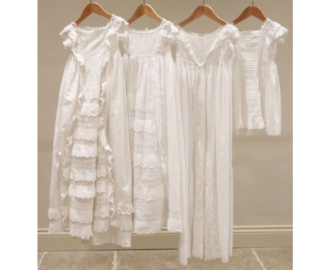 A late 19th century fine white cotton christening gown, with hand worked broderie anglaise front panels to skirt and bodice (