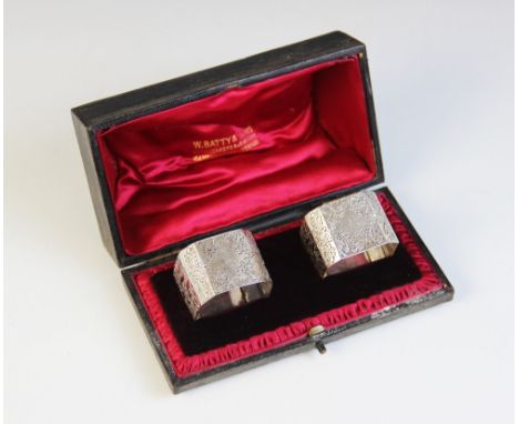 A pair of Victorian silver napkin rings, Atkin Brothers, Sheffield 1897, each of square form with canted corners, engraved wi