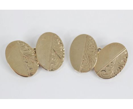 A pair of 9ct gold cufflinks, each oval form panel with foliate decoration, 18mm x 13mm, marks for Birmingham 1992, gross wei