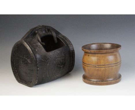 A blackjack leather ale vessel, of barrel form, rectangular patch later removed, 22cm high, along with a treen mortar, of typ