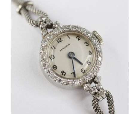 A ladies vintage Marvin platinum diamond set cocktail watch, circular dial with Arabic numerals, single cut diamonds set to b