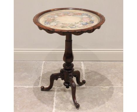 A mid 19th century glazed rosewood pedestal table, the circular top inset with a foliate needlework panel within a scalloped 