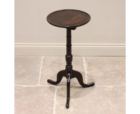 A George III oak tripod table or candle stand, the circular top with a raised moulded rim, upon a ring turned tapering gun ba