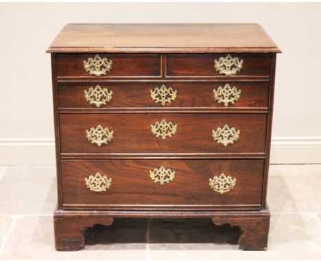 A mid 18th century oak chest of drawers, formed as four long graduated drawers (later re-constructed), the top drawer moulded