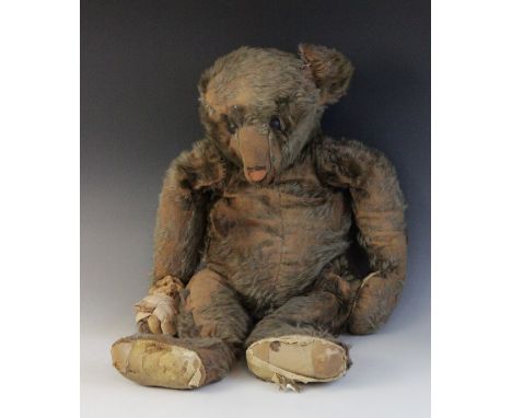 "Joulka" - An articulated teddy bear (possibly Steiff), early 20th century, the wood wool filled bear with heavily worn golde