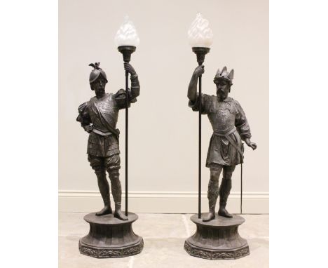 A pair of late 19th century bronzed spelter figural floor standing lamps, each modelled as a conquistador holding a lamp stan