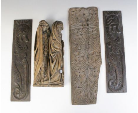A 17th century religious figural oak carving, modelled as two saints standing beside each other, 38cm high, along with a pair