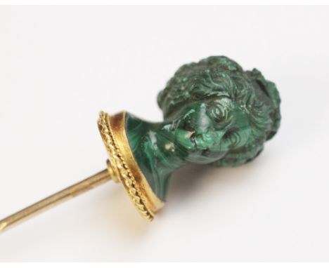 A malachite stick pin, carved in the classical style as a female head with waved hair and a crown of grapes and vine leaves, 