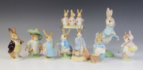Nine Beswick Beatrix Potter rabbit figures, comprising: Peter Rabbit (first version: small size; first variation: dark blue j
