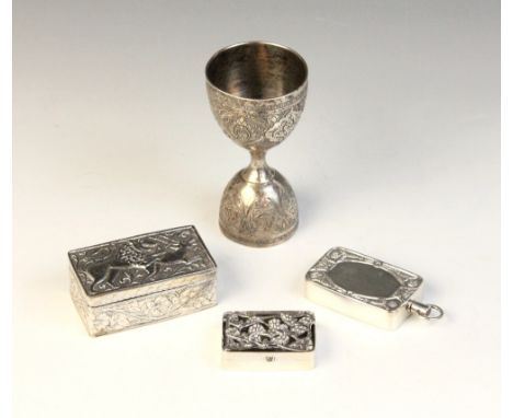 An Indian silver coloured double-ended spirit measure, of typical form with scrolling foliate panel decoration, 9.3cm high, t