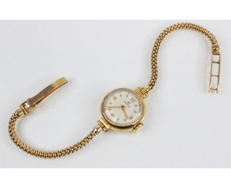A Ladies Cyma 9ct gold vintage wristwatch, the circular dial with engine turned decoration, Arabic numerals and diamond shape