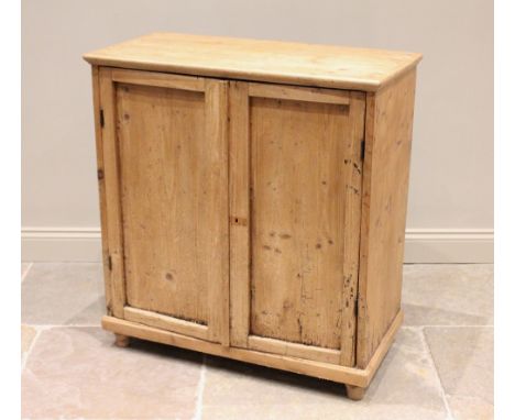 A Victorian pine and later constructed two door cupboard, the rectangular top with moulded edge above a pair of panelled door