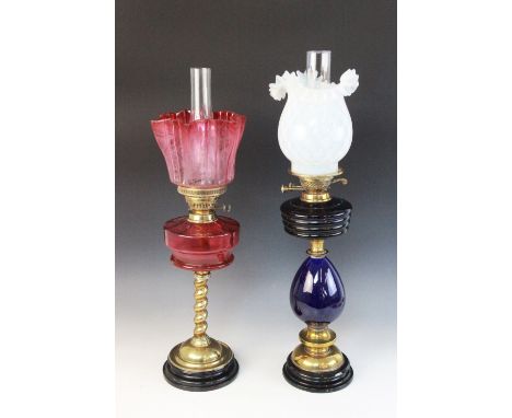 A Victorian brass and Bristol blue glass oil lamp, the crimped opaline shade above a lobed blue glass reservoir and a blue ce