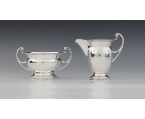 A George VI silver milk jug and sucrier, Charles S Green & Co Ltd, Birmingham 1938, each of plain polished design with scroll