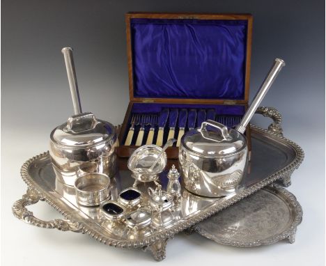 A large twin-handled silver plated presentation tray, of rounded rectangular form with gadroon border raised upon four scroll