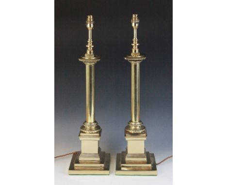 A pair of brass Corinthian column table lamps, each cast with a plain column upon a wreath collar and integrated stepped plin