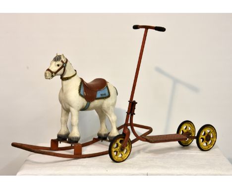 A vintage Tri-ang rocking horse, the body of moulded form, raised on metal rocker, total length 34in. (86.4cm.); together wit