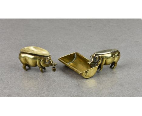 Two Edwardian novelty brass pigs - smoking related, probably French, the first fashioned standing at a trough, his back with 