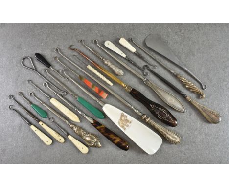 A collection of various Victorian and later button hooks (22), to include white metal examples, early plastic versions, faux 