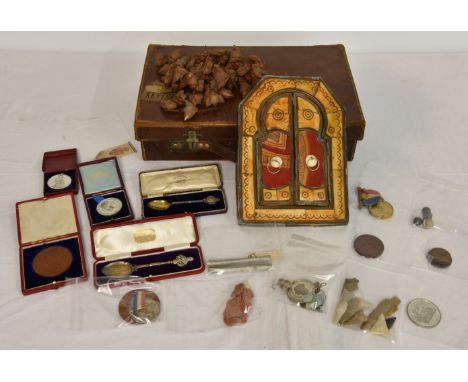 A rummage case of curiosities - medallions etc, to include a shard of aluminium from Zeppelin Wigborough 24/9/16; four lead m