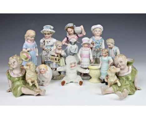 A small collection of bisque and porcelain figures, comprising of a pair of bisque figures of girl and boy dressed as adults,