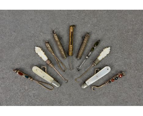 A collection of Victorian and later miniature silver and base metal button hooks, to include two M.O.P and silver folding ver