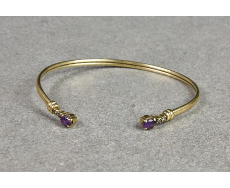 A 9ct gold, amethyst and diamond flexible torq style bangle, the terminals each set with a single oval cut amethyst and a pai