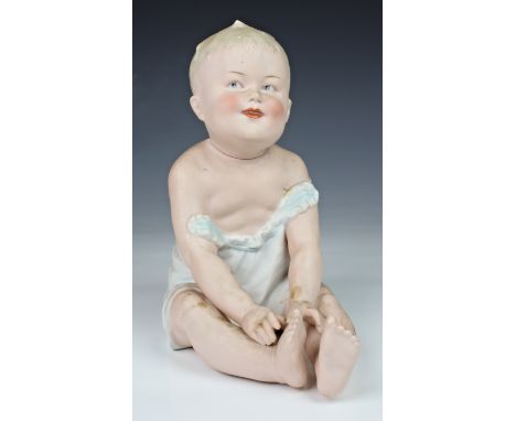 A early 20th century rare and unusual novelty German all-bisque piano baby doll as a decanter, attributed to Gebruder Heubach