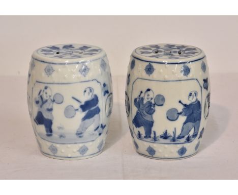 A pair of modern miniature Chinese barrel-shaped garden seats, blue &amp; white, of typical form but miniature, depicting fig