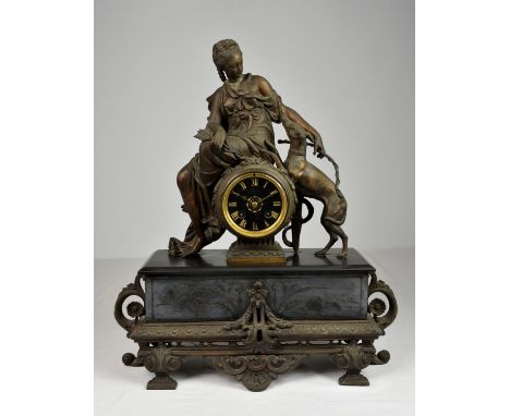 A 19th century patinated spelter figural mantel clock, probably French, surmounted with classical maiden and hunting dog, hav
