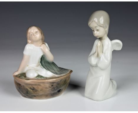 A Royal Copenhagen Thumbelina 4374 figurine, depicting Thumbelina in a walnut shell, together with a Nao Angel figure. (2)