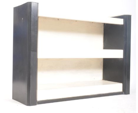 A mid 20th century circa 1940s Art Deco metal painted floor shelf unit having three shelves flanked by cantered upright suppo