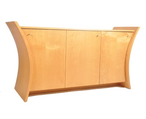 A vintage early 2000s Danish inspired light oak curved tapering sides sideboard cabinet. The credenza having a straight top o