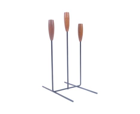 A 20th century Danish inspired candlestick&nbsp;holder having three turned teak holder tops supported by metal wire stems upo