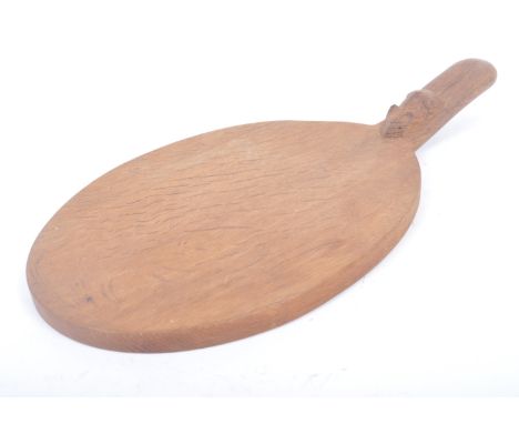 Robert ' Mouseman ' Thompson of Kilburn - A solid English oak hand carved single handle cheeseboard. Of oval form with diagon