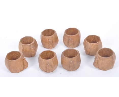 Robert ' Mouseman ' Thompson of Kilburn - A set of eight solid English oak hand carved faceted napkin rings. Each measuring a