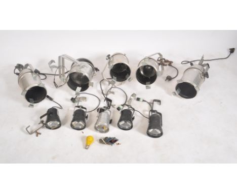 A selection of vintage 20th century aluminum cased theater spot lamp lights with each of barrel from and retaining their ceil