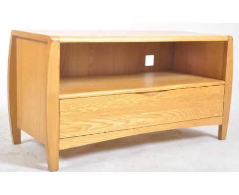 Ercol - A contemporary Ercol light solid oak TV / hi-fi unit media cabinet. The unit having a rounded finger joints edges ove