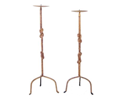 A pair of vintage 20th century Brutalist style wrought iron floor standing prickets. Each candlestick with circular wax drip 