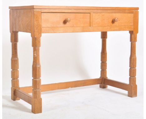 Robert ' Mouseman ' Thompson of Kilburn - A solid English oak hand carved two drawer hall side table. Raised on octagonal blo