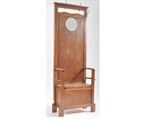 A vintage 20th century 1940s Art Deco oak hallstand settle. The hall stand being of upright form with brass hooks to the top 