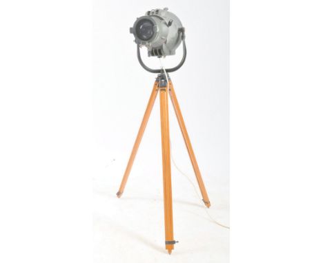 A retro vintage mid 20th century Strand Electric stage spotlight / theatre lamp, on wooden tripod support. The light in a gre