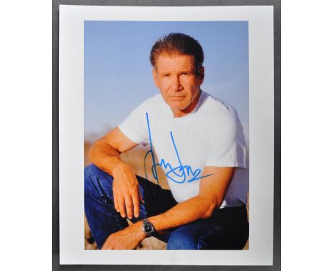 Star Wars - Harrison Ford (Han Solo) - an autographed 8x10" colour photograph of Ford seated in a white shirt. Signed in blue