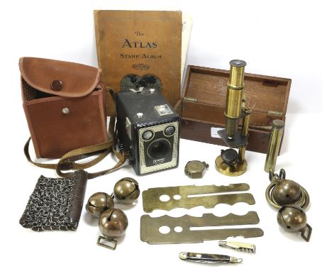 Students brass microscope, 19cm high, in a mahogany box, together with box Brownie, brass horse bells, stamp album and other 