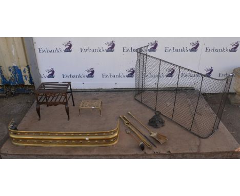 A fireguard, fender, fire irons and associated items including an oil lamp and a metal freestanding trivet raised on three su