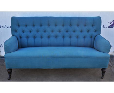 A n early 20th Century blue fabric upholstered button back settee raised on turned supports terminating in casters. 160 cm wi