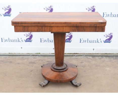 A rosewood card table, 19th Century, the rectangular top enclosing a circular green baize playing surface, on facetted suppor