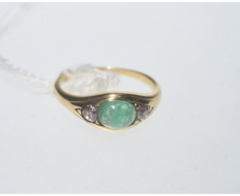 An emerald and diamond ring, the oval cabochon emerald weighing approx. 1 carat flanked by diamonds and on an indistinctly ma