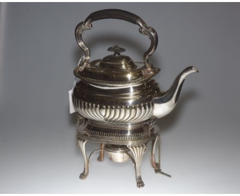 An Edwardian silver plate teapot on stand with burner, the gadrooned body raised on a stand terminating in four claw feet. He